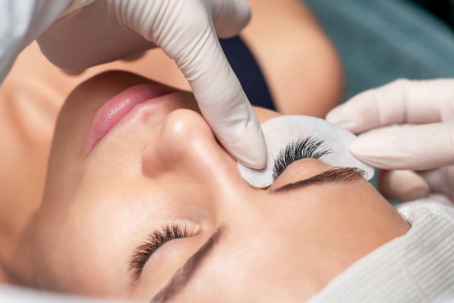 Client relaxing with eyes closed during lash lift treatment