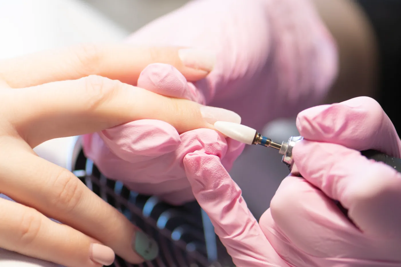 Nail technician applying gel polish during a gel manicure in Uluwatu