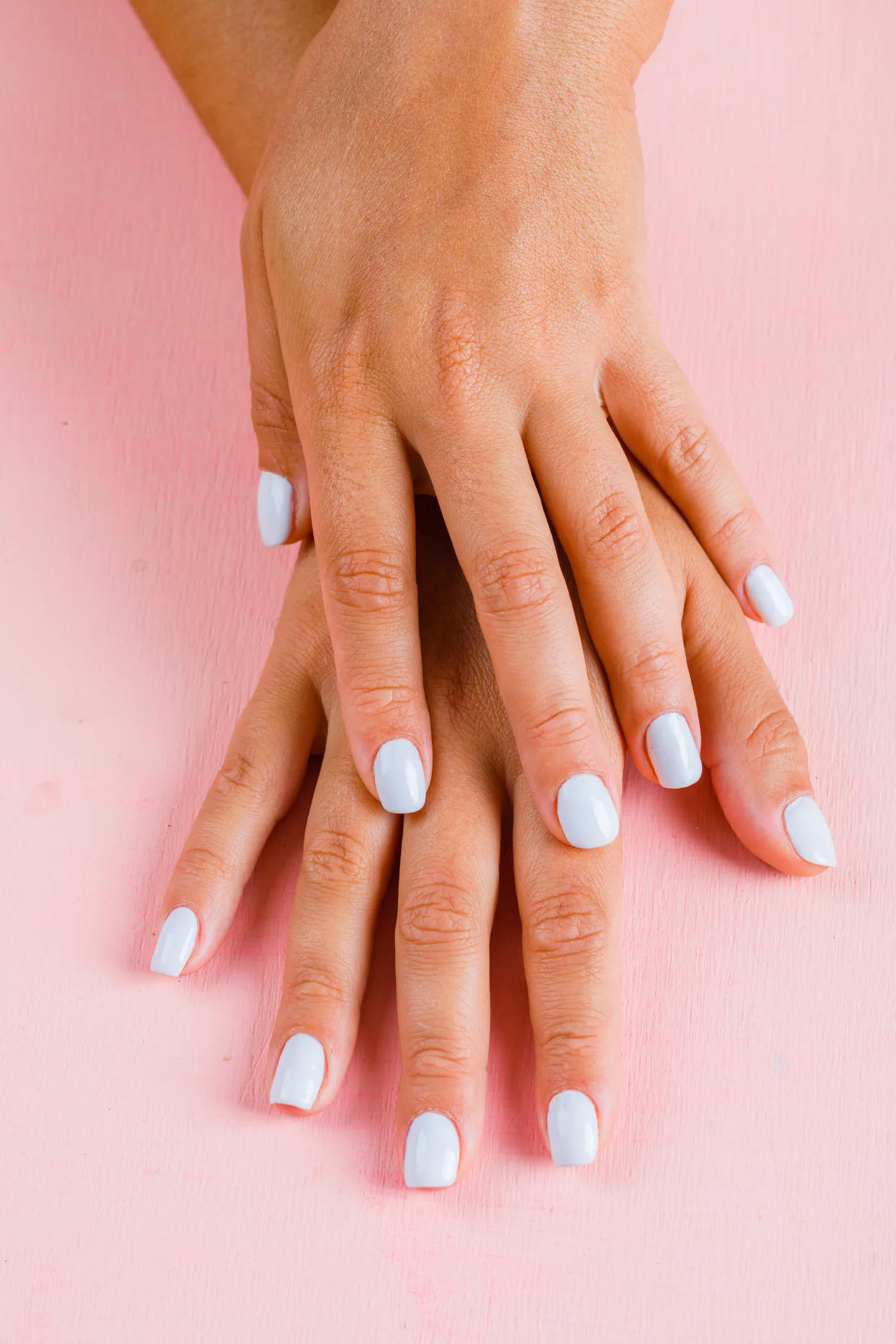 Hands with a fresh white gel manicure